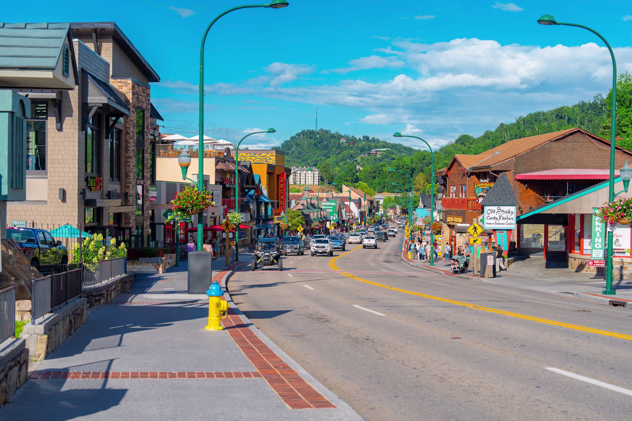 Downtown Gatlinburg Tennessee street with Smoky Mountain views, representing Gatlinburg real estate and mountain lifestyle.